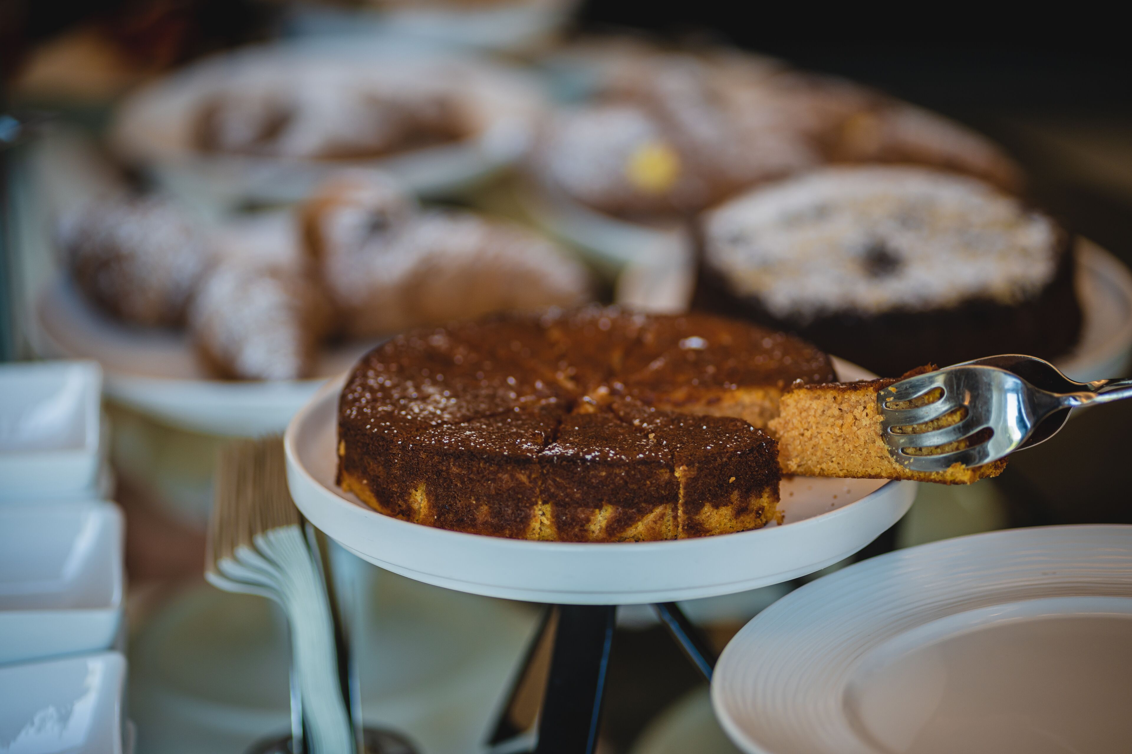 A cake on a white plate with a fork.