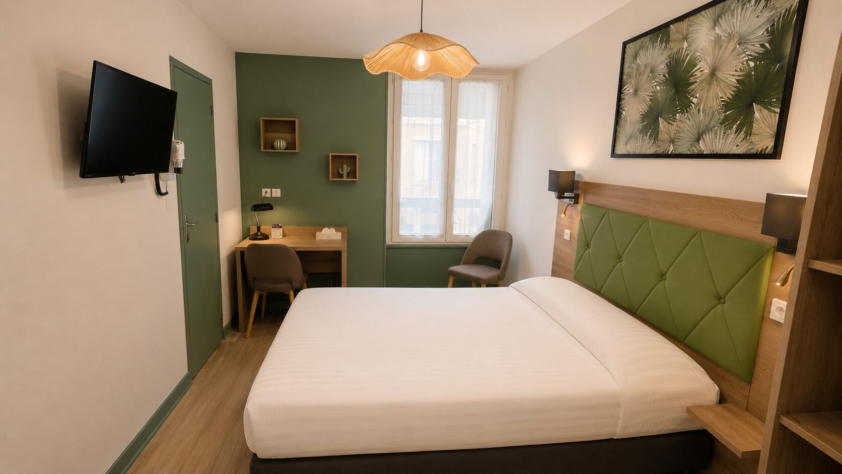 A hotel room with a bed, desk, chair, television, and artwork on the wall.