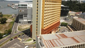 A high-rise hotel with a prominent 'C5' sign, a modern building with a glass facade, and a large circular structure nearby. - Gaya Centre Hotel (Kota Kinabalu)