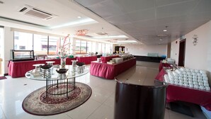A spacious room with a buffet setup, large windows, and a modern ceiling design. - Gaya Centre Hotel (Kota Kinabalu)