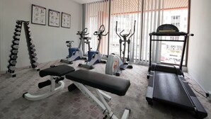 A gym with treadmills, elliptical machines, and free weights. - Gaya Centre Hotel (Kota Kinabalu)