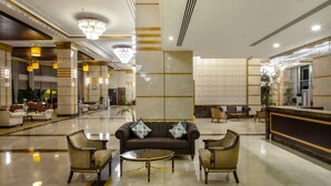 A spacious lobby with a central seating area, a reception desk, and a chandelier. - Crowne Plaza Hotel Istanbul - Asia by IHG (Istanbul)