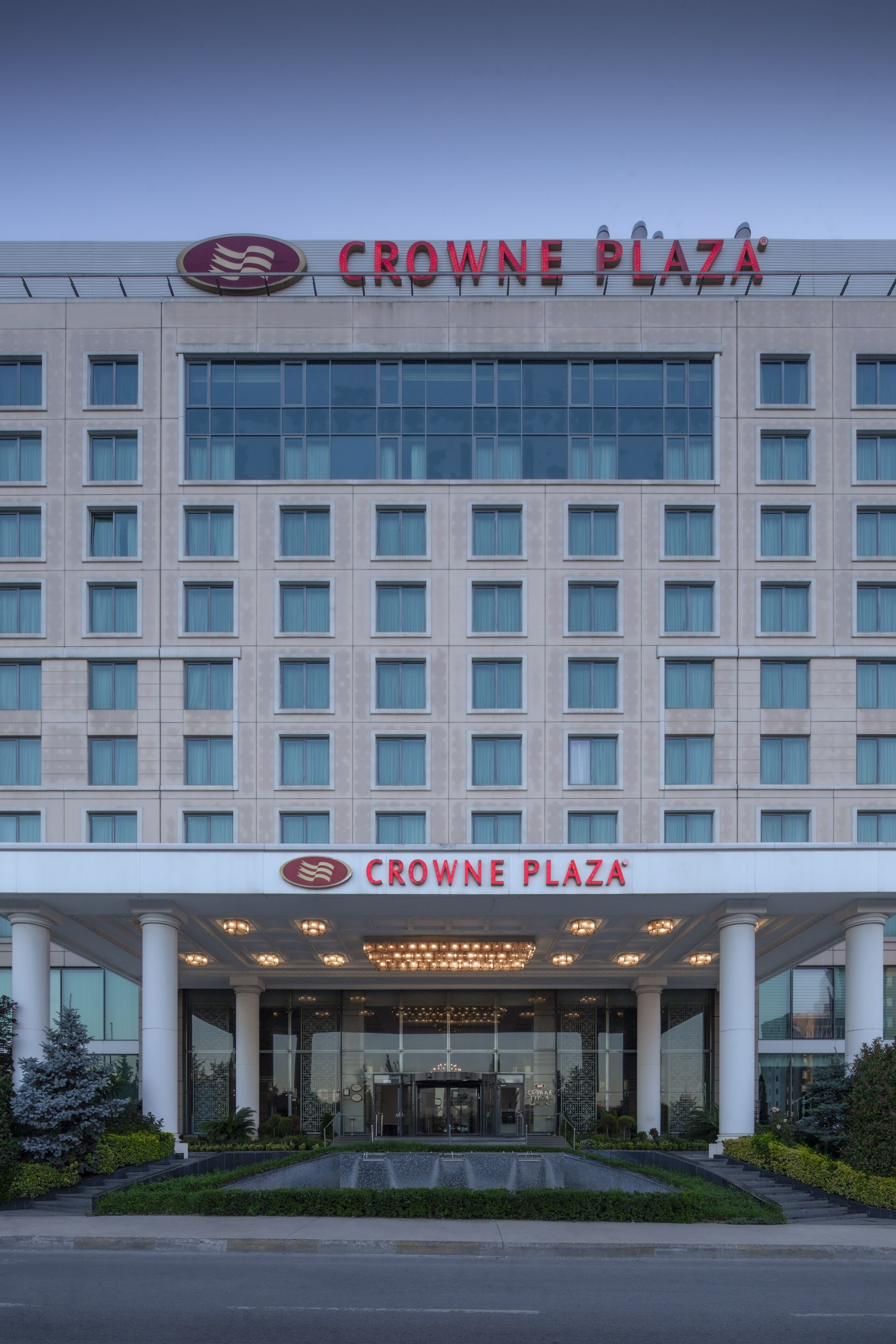 A hotel with a modern facade, large windows, and a prominent entrance with a canopy.