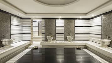 Experience a sleek bathroom with a large floor, white sinks, and a curved ceiling.