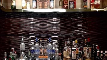 A bar area with shelves of various liquor bottles.