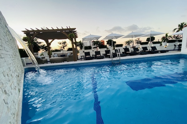 Outdoor pool, open 9:00 AM to 9:00 PM, pool umbrellas, sun loungers