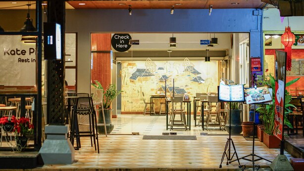The entrance of a hotel with a check-in counter, a signboard, and a tiled floor. - Parasol Inn Chiang Mai Old City (Chiang Mai)