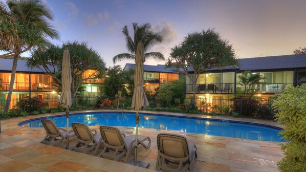 Outdoor pool, a heated pool, open 8 AM to 9 PM, pool umbrellas