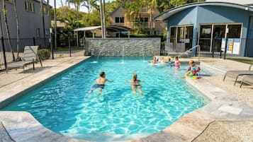 Outdoor pool, a heated pool, pool umbrellas, pool loungers
