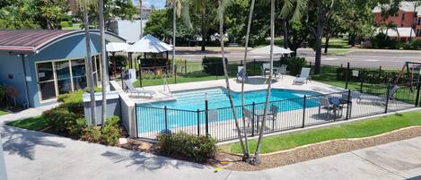 Outdoor pool, a heated pool, pool umbrellas, pool loungers