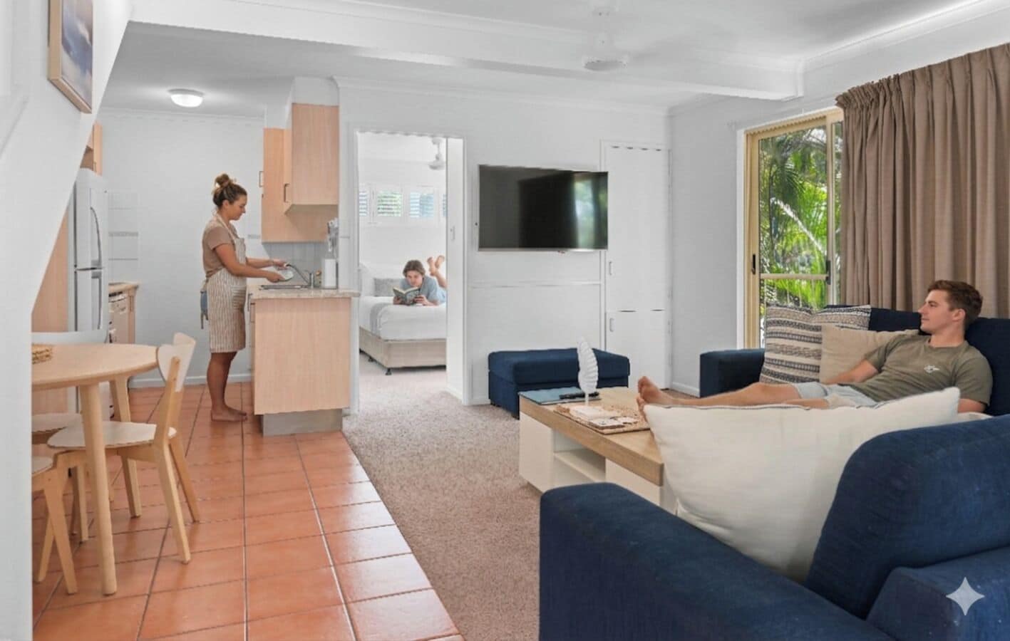 A modern living room with a sofa, a TV, and a dining area with a table and chairs.