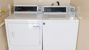A laundry area with two commercial dryers and a washing machine. - Budget Inn Barstow (Barstow)
