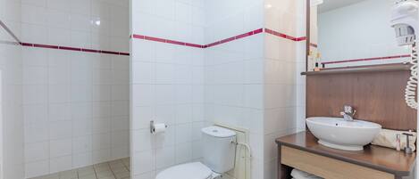 Een badkamer met toilet, wastafel en douche.