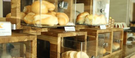 A bakery display with various baked goods in clear containers.