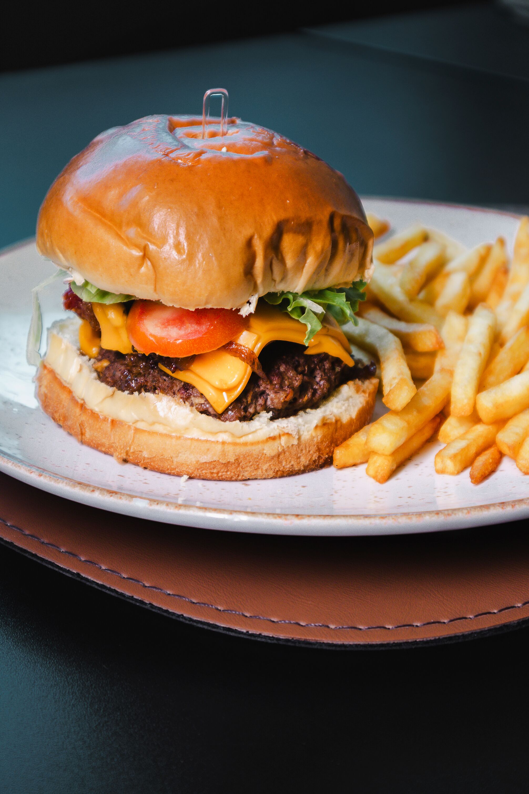 A hamburger with fries on a plate.