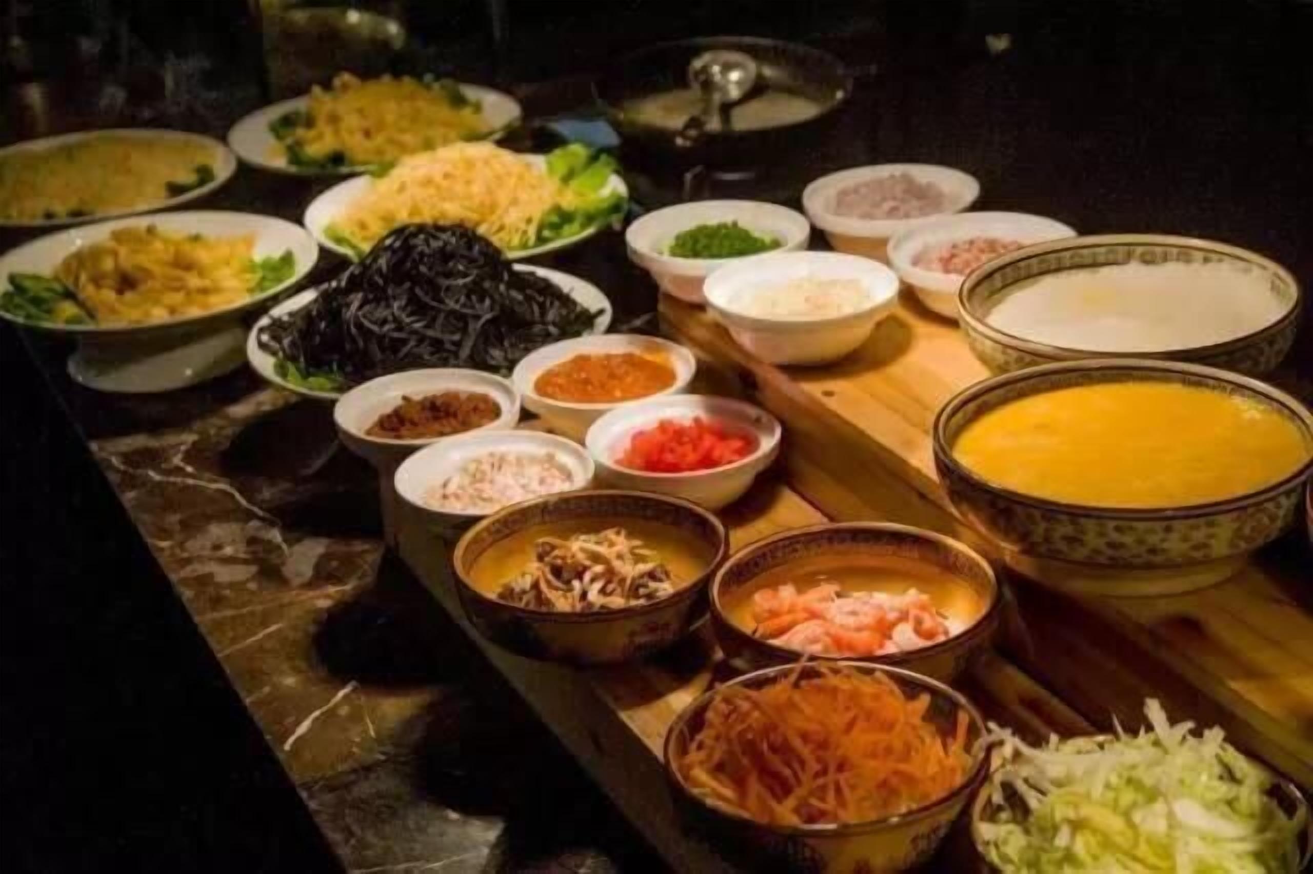 A variety of dishes and ingredients laid out on a table, likely for a buffet or tasting event.