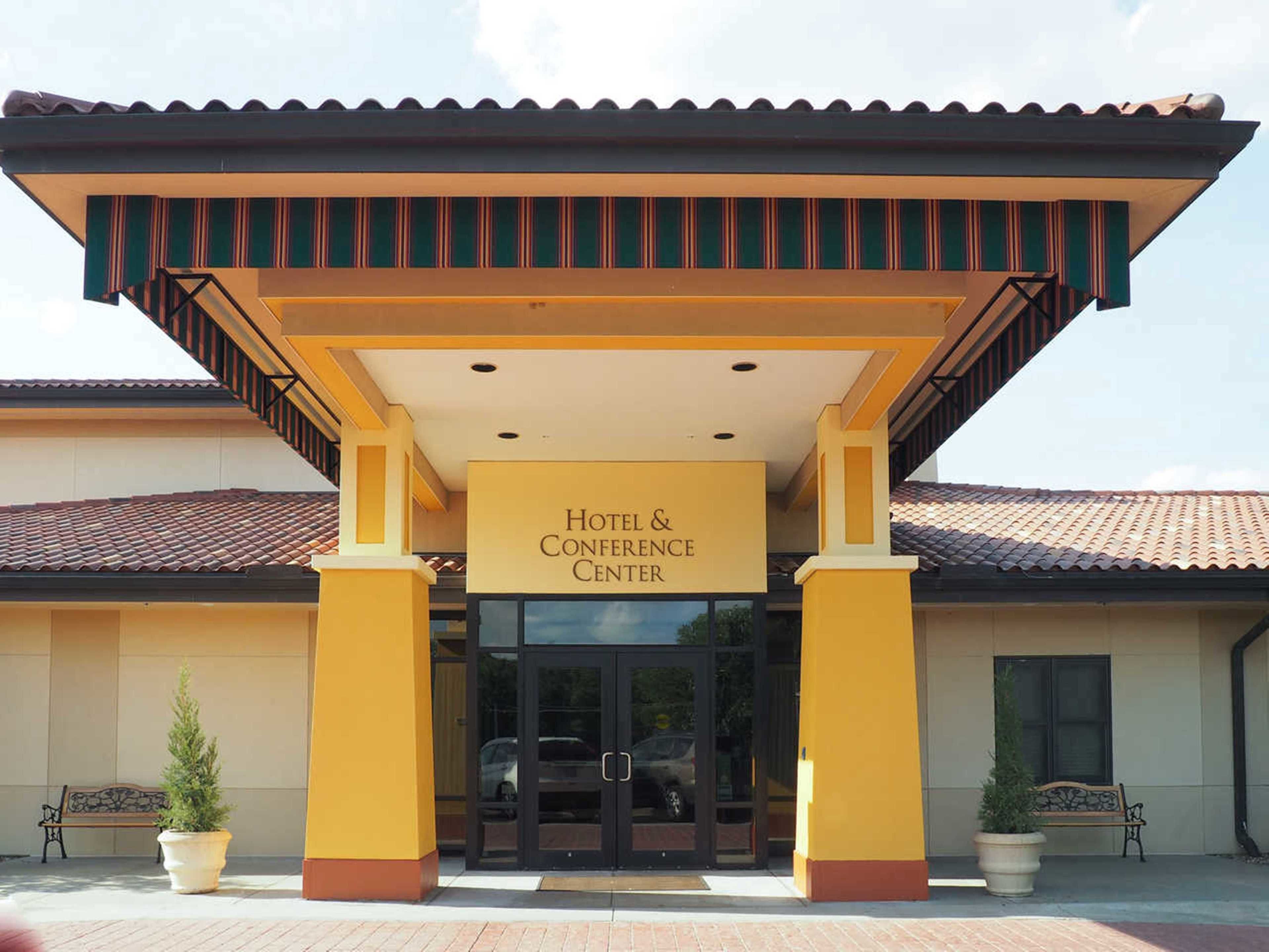 A hotel entrance with a sign reading "Hotel & Conference Center".
