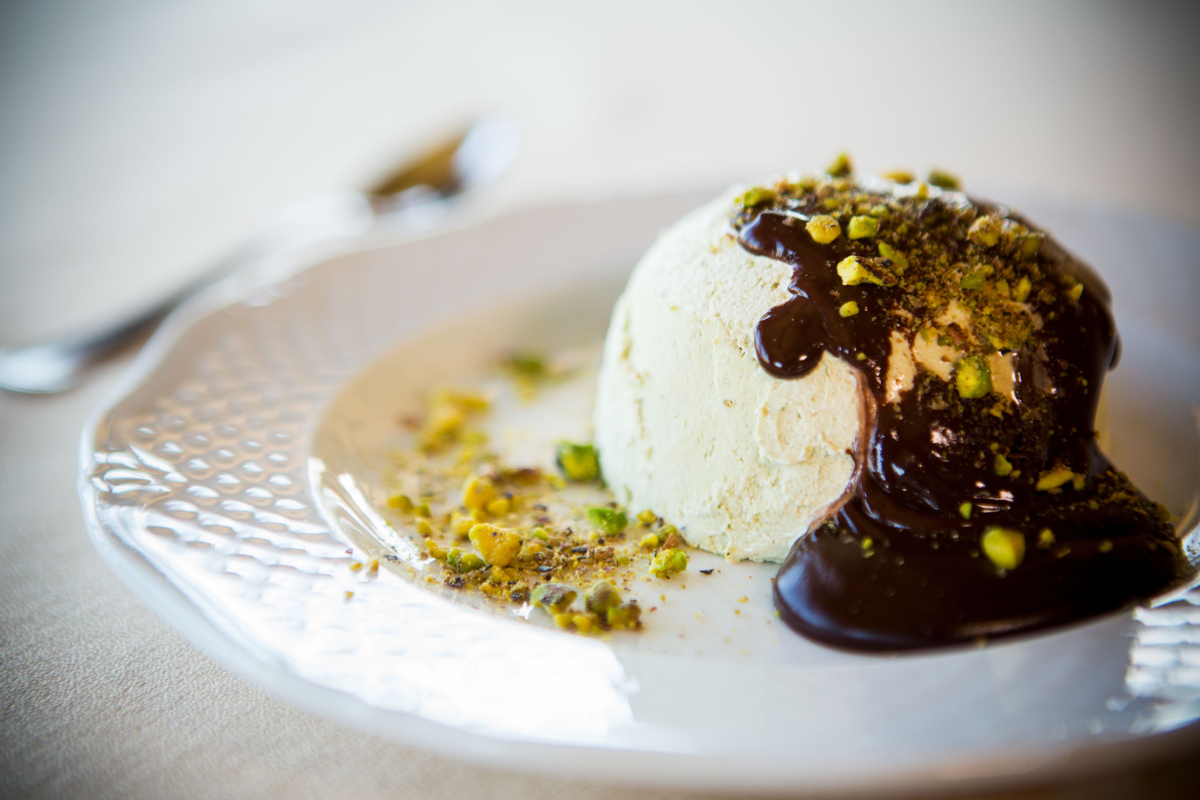 A dessert on a plate with a spoon.
