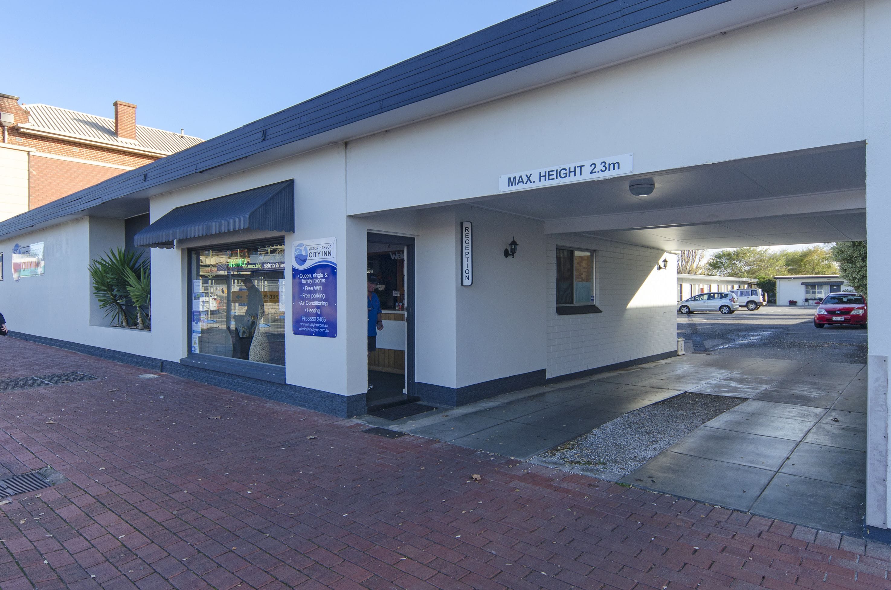 A building with a sign indicating a maximum height of 2.3m.