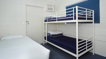 A bunk bed room with a white door, a white air conditioning unit, and a blue curtain.