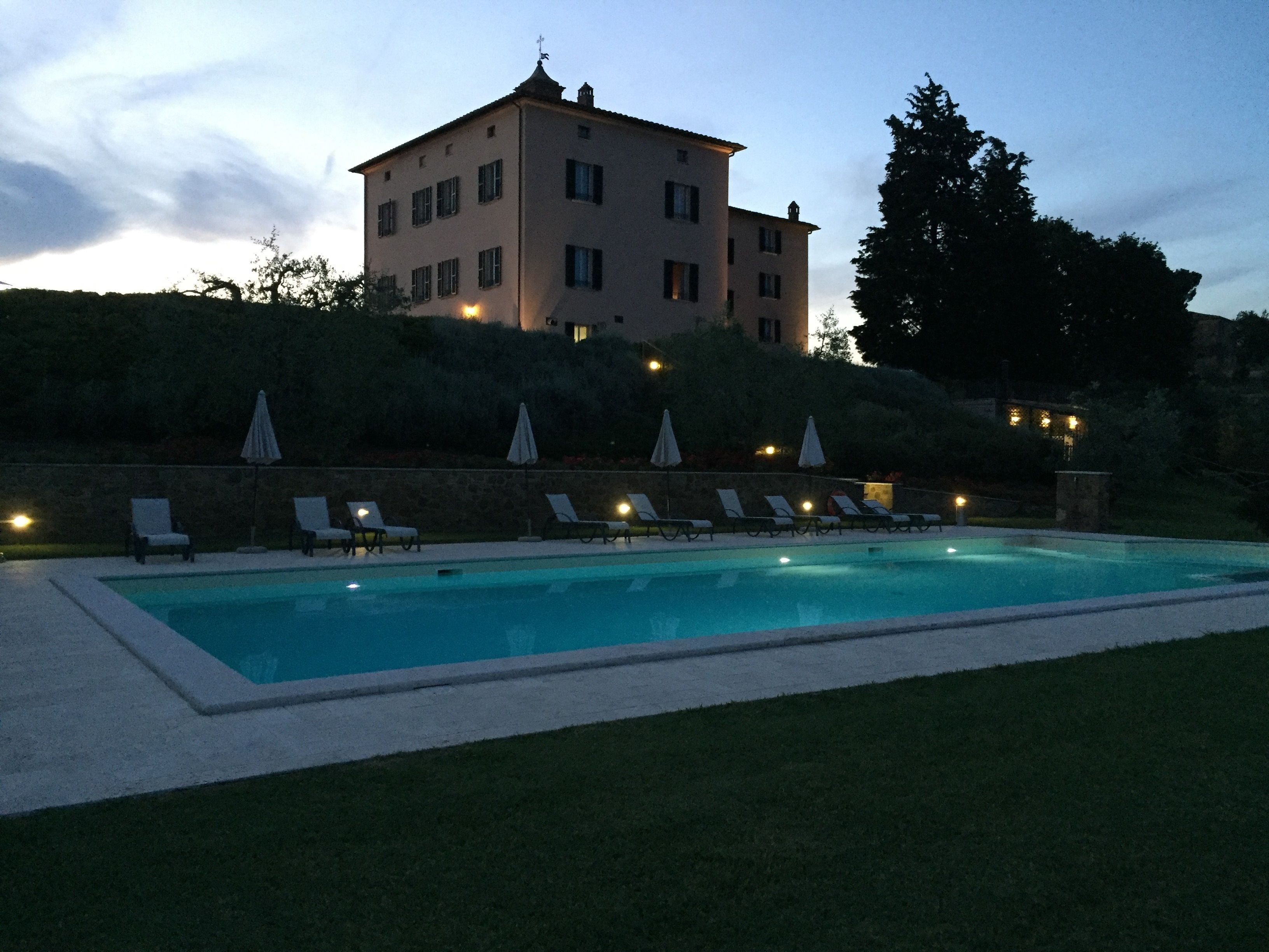 Una piscina al aire libre, sillones reclinables de piscina