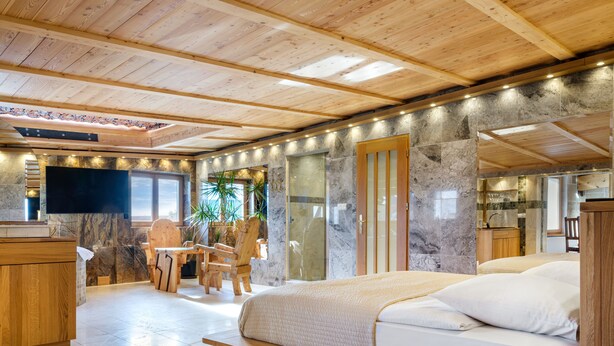 A modern bedroom with a wooden bed, a wooden desk, and a chair. - Aparthotel Stare Miasto (Kraków)