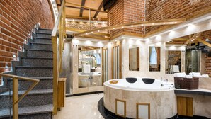 A modern bathroom with a freestanding bathtub, a marble vanity, and a glass-enclosed shower area. - Aparthotel Stare Miasto (Kraków)