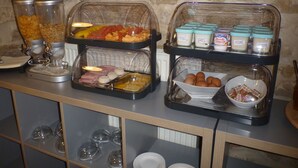 A buffet setup with various food items and condiments. - Logis Hotel La Bastide St Bach (Suze-la-Rousse)