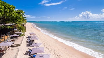 En la playa, sillas reclinables de playa, sombrillas, snorkel