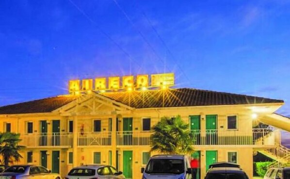 A building with a sign that reads "AIRPORT" and multiple balconies.