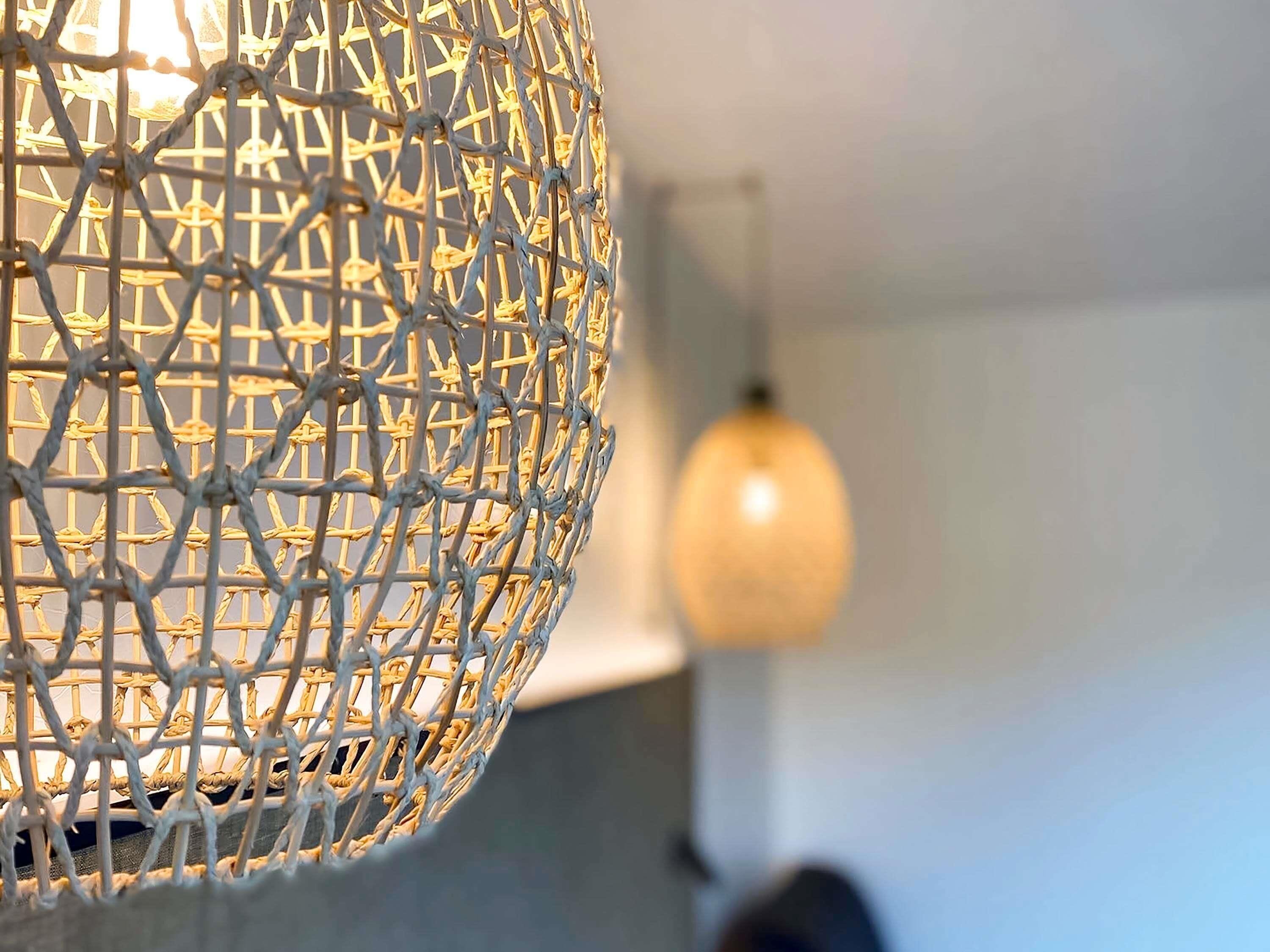 A close-up of a spherical woven light fixture.
