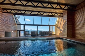 An indoor swimming pool with a view of mountains through large windows. - Hotel Le Grand Tetras (Font-Romeu-Odeillo-Via)
