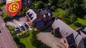 An aerial view of a traditional building with a sign reading "The Old Rectory." - The Old Rectory Inn (Callander)