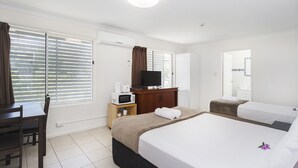 A hotel room with a bed, a desk, a TV, a microwave, and a wardrobe. - Sunshine Beach Resort (Miami)