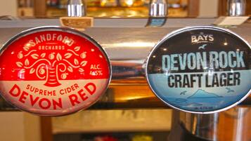 Two beer taps labeled "Devon Red" and "Devon Rock Craft Lager".