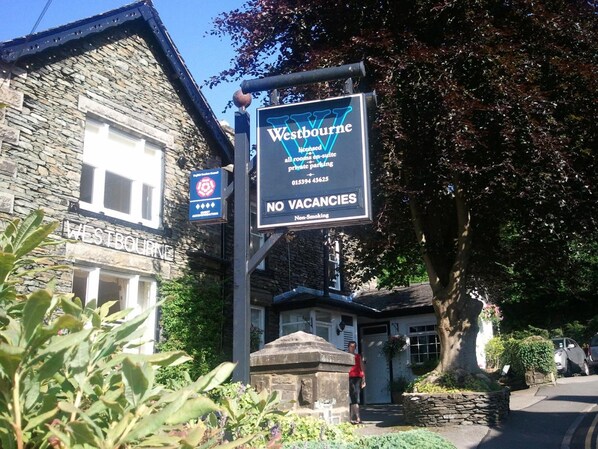 A sign for Westbourne hotel with a no vacancies notice and a non-smoking policy.