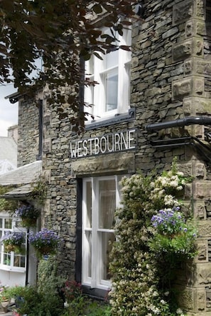 A stone building with a sign reading "WESTBOURNE".