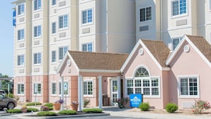 A multi-story hotel with a beige facade, a brown roof, and a sign for 'Microtel by Wyndham'. - Microtel Inn & Suites by Wyndham Harrisonburg (Harrisonburg)