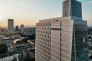 A modern hotel with a prominent glass facade and a sign indicating it is a JW Marriott. - JW Marriott Hotel Frankfurt (Frankfurt)