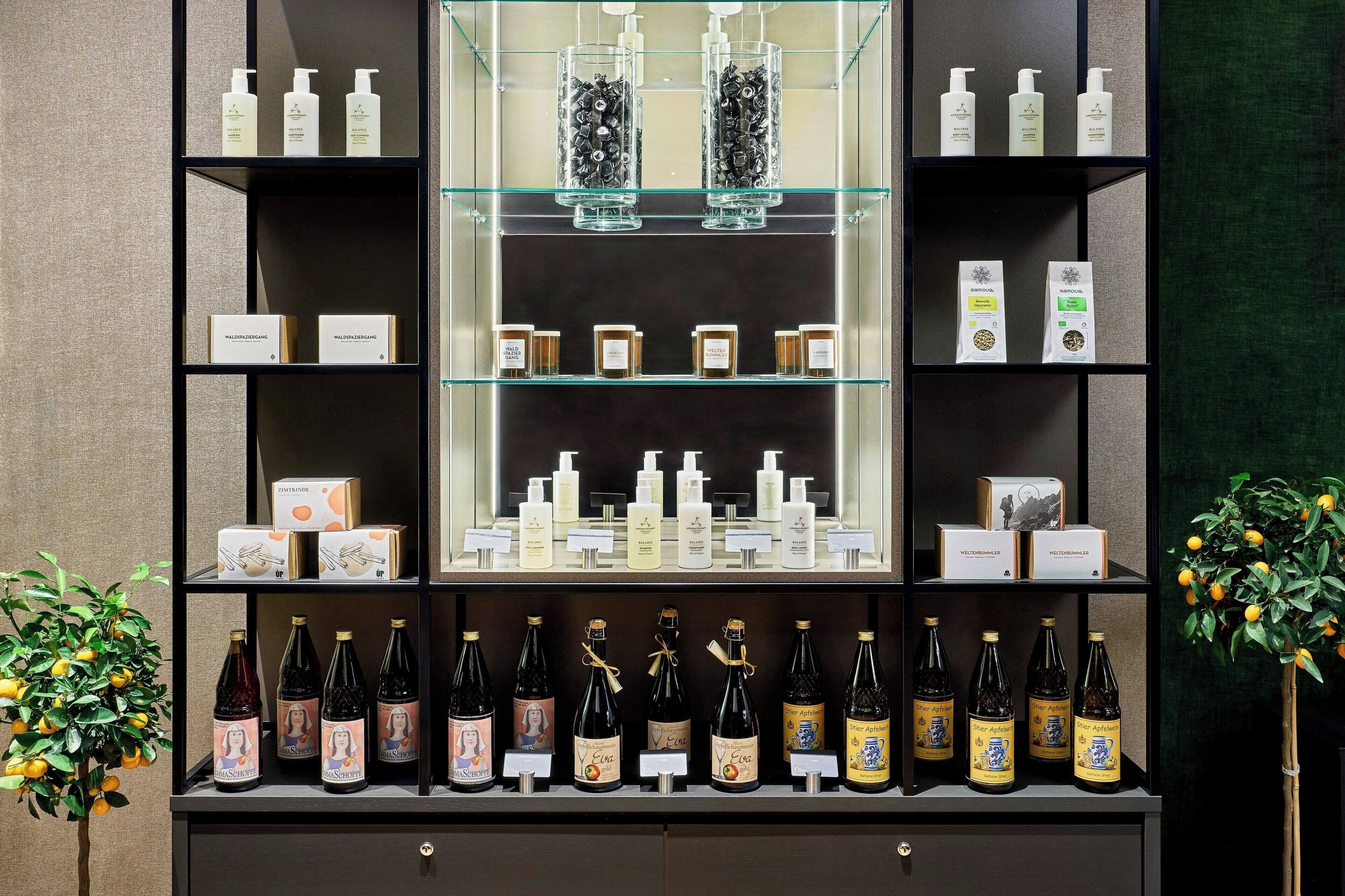 A display of various products including bottles and boxes, likely in a retail or hotel setting.