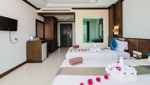 A hotel room with two beds, a TV, a desk, and a bathroom visible through the door. - Azure Bangla Phuket (Patong)