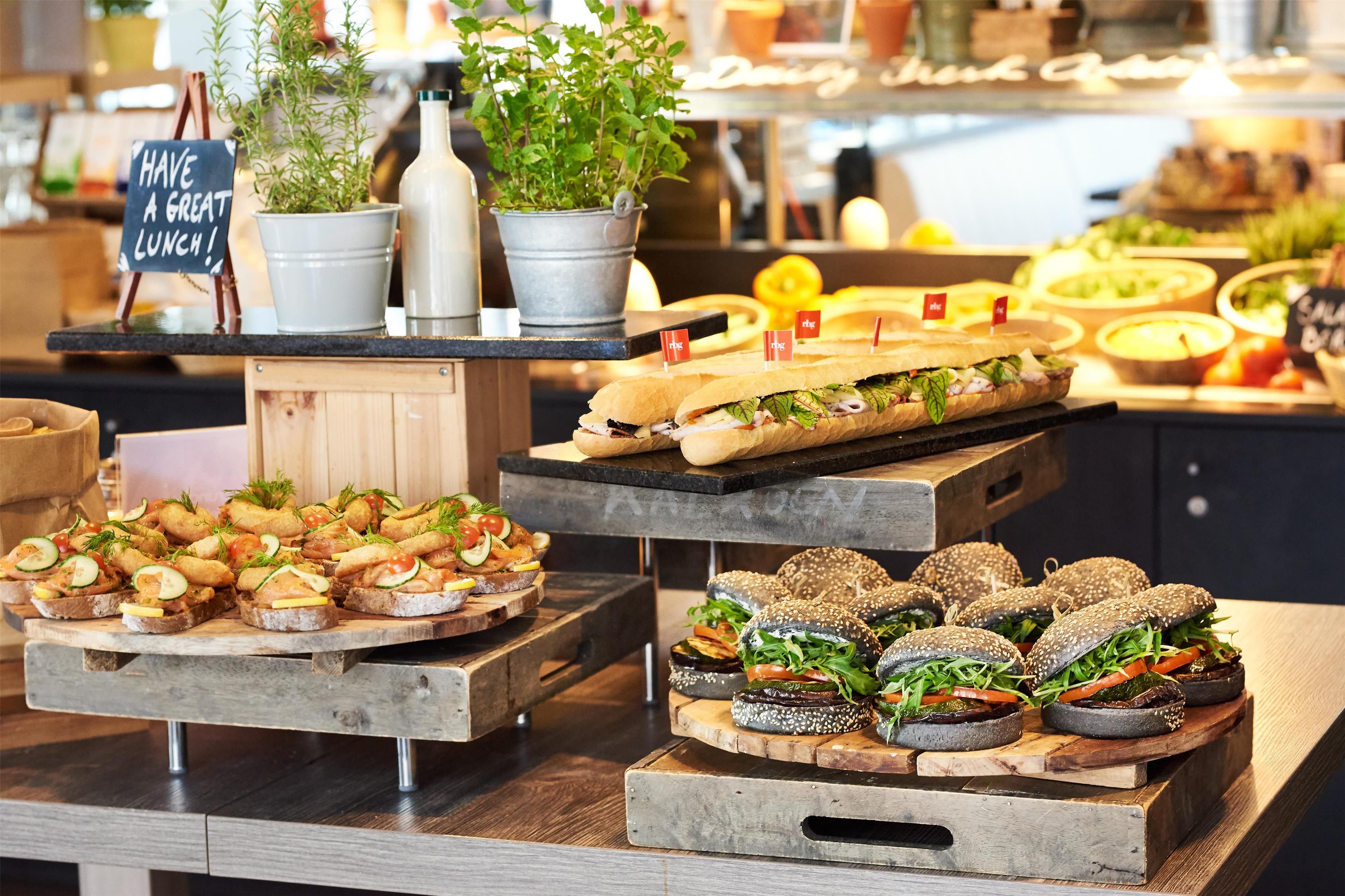 A buffet with various food items, including sandwiches and appetizers, displayed on wooden boards.