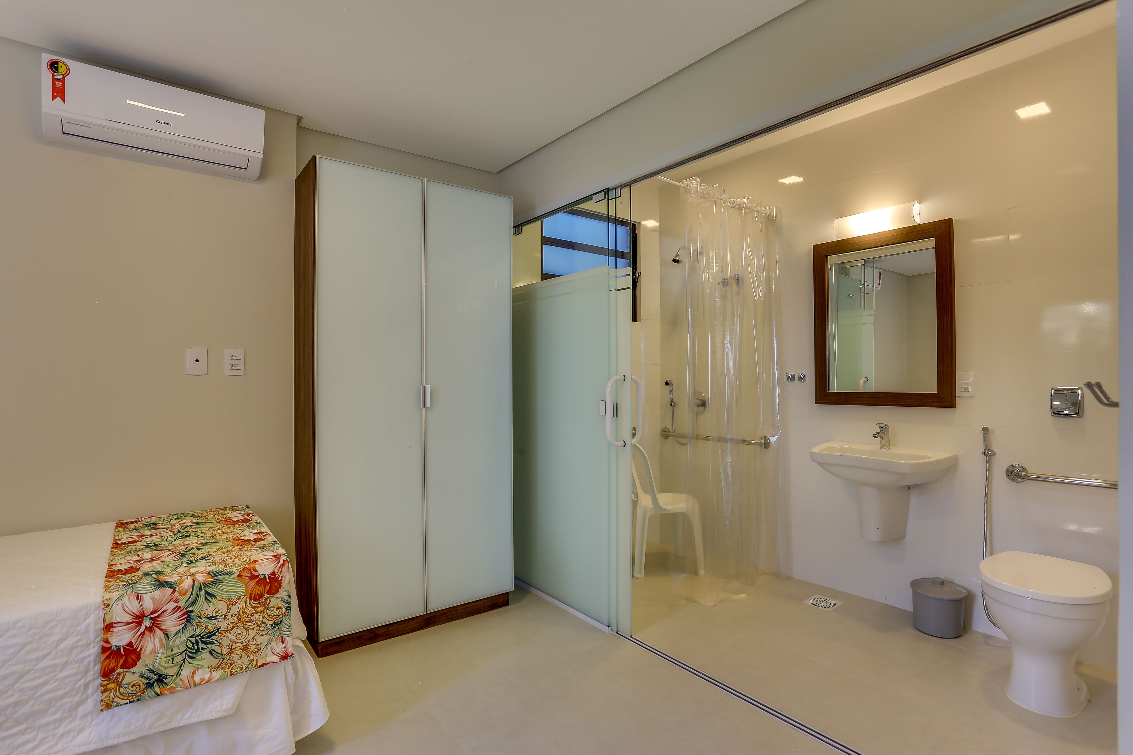 A modern bathroom with a glass shower enclosure, a white sink, and a toilet.
