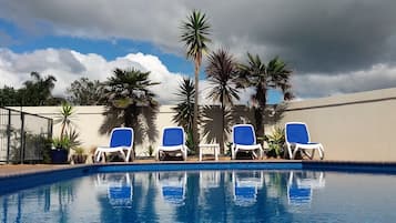 Seasonal outdoor pool, pool umbrellas, pool loungers
