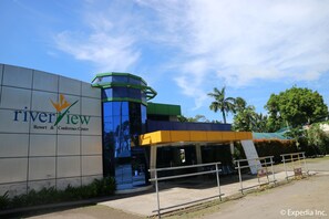 A River View Resort & Conference Center with a modern design, featuring a prominent logo, a glass facade, and a covered outdoor area.