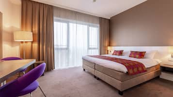 Luxe beddengoed, een minibar, een kluis op de kamer, een bureau