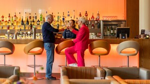 A bar area with multiple stools and a bar counter.