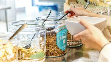 A food display with various granola and cereal options.