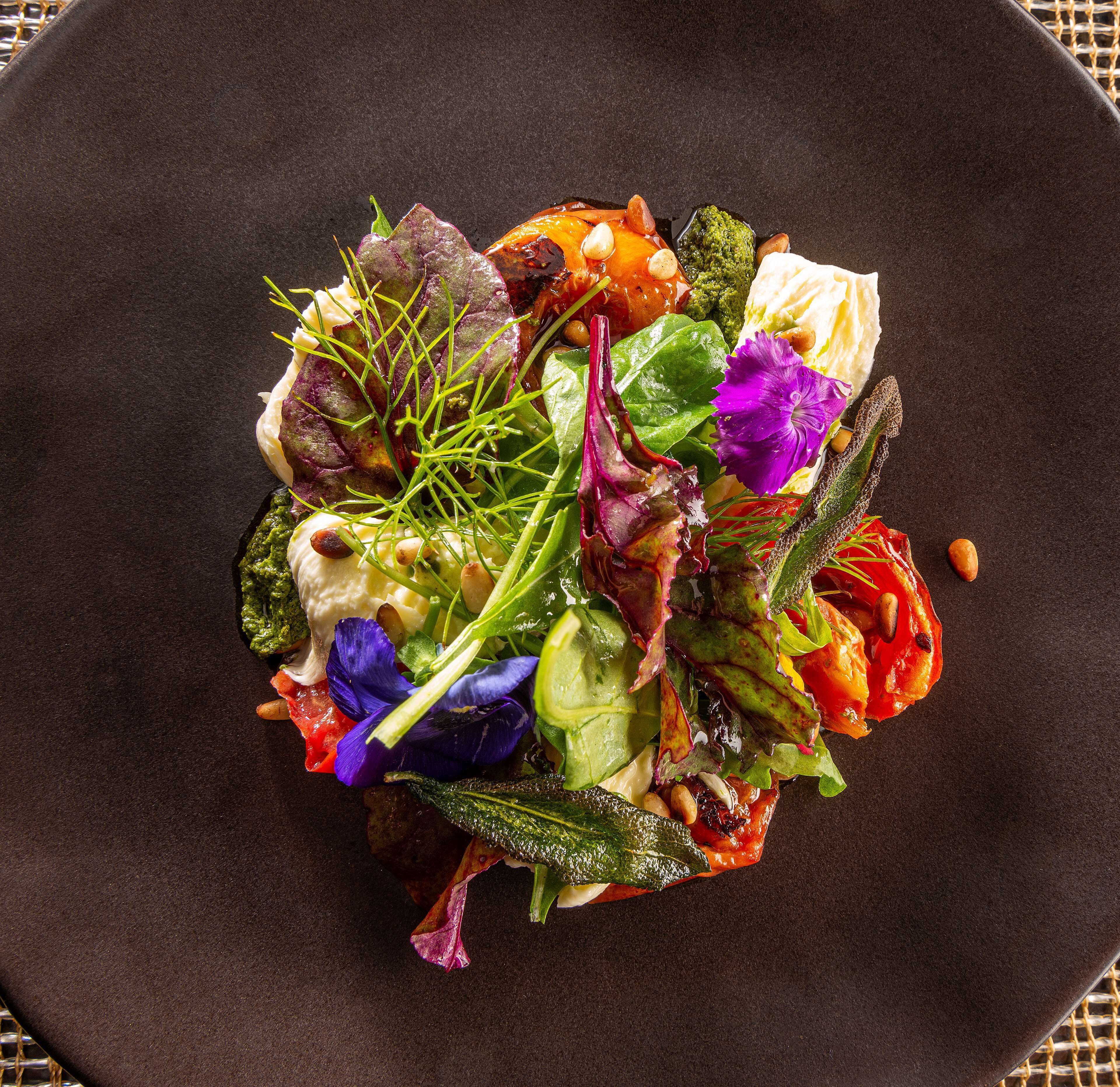 A plate of colorful mixed greens and vegetables.