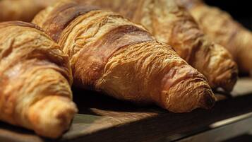 A close-up of several croissants on a wooden surface.
